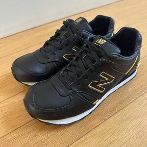 New Balance Women’s 554 Classic Black and Gold Sneakers